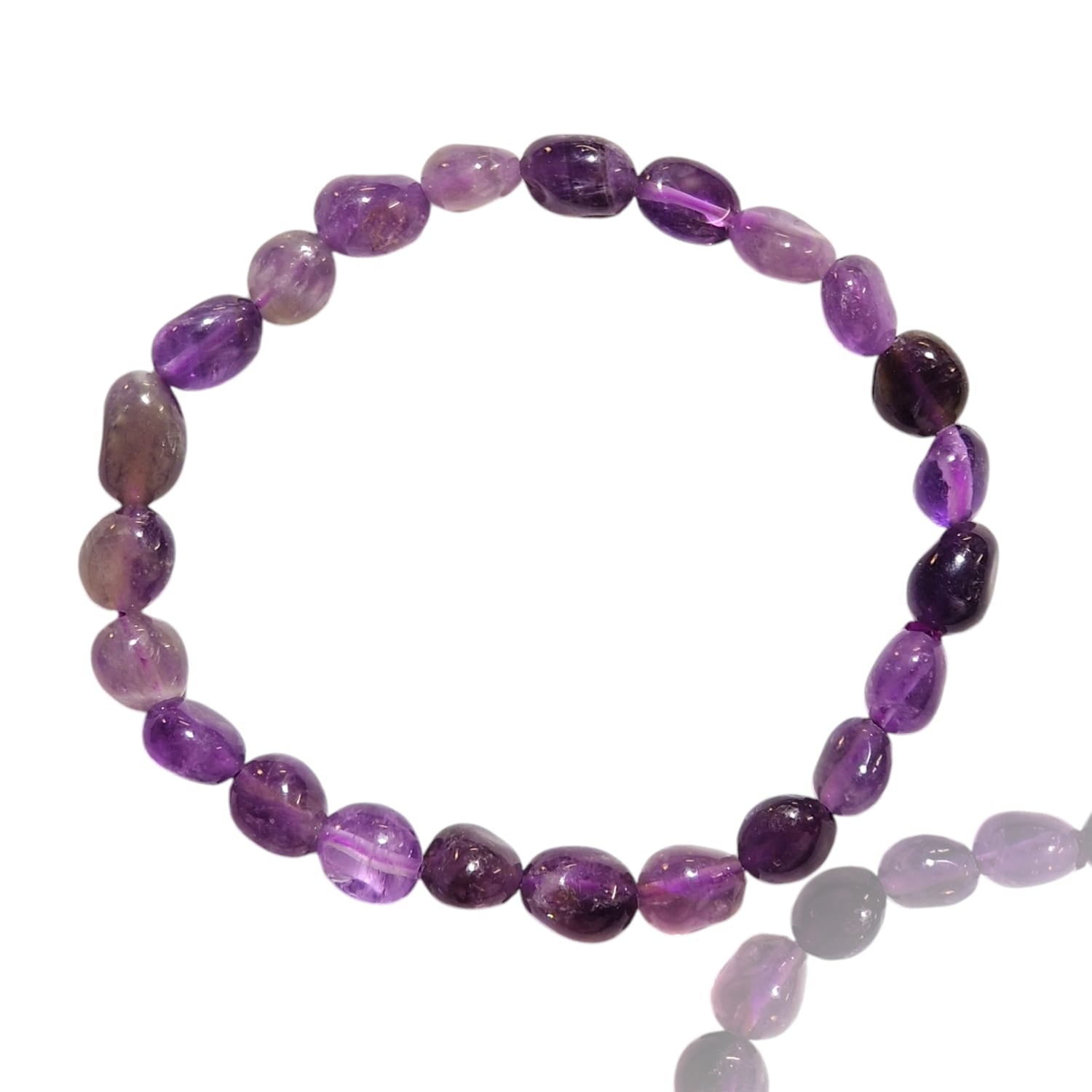 GeoFossils stretch nugget bracelet made from polished amethyst stones in varying shades of purple, from deep violet to soft lavender. The stones are irregularly shaped, giving the bracelet a natural, raw aesthetic while maintaining a smooth, polished finish. The elastic band allows for an adjustable fit, and the rich purple tones of the amethyst stones evoke a sense of calm and spiritual energy.