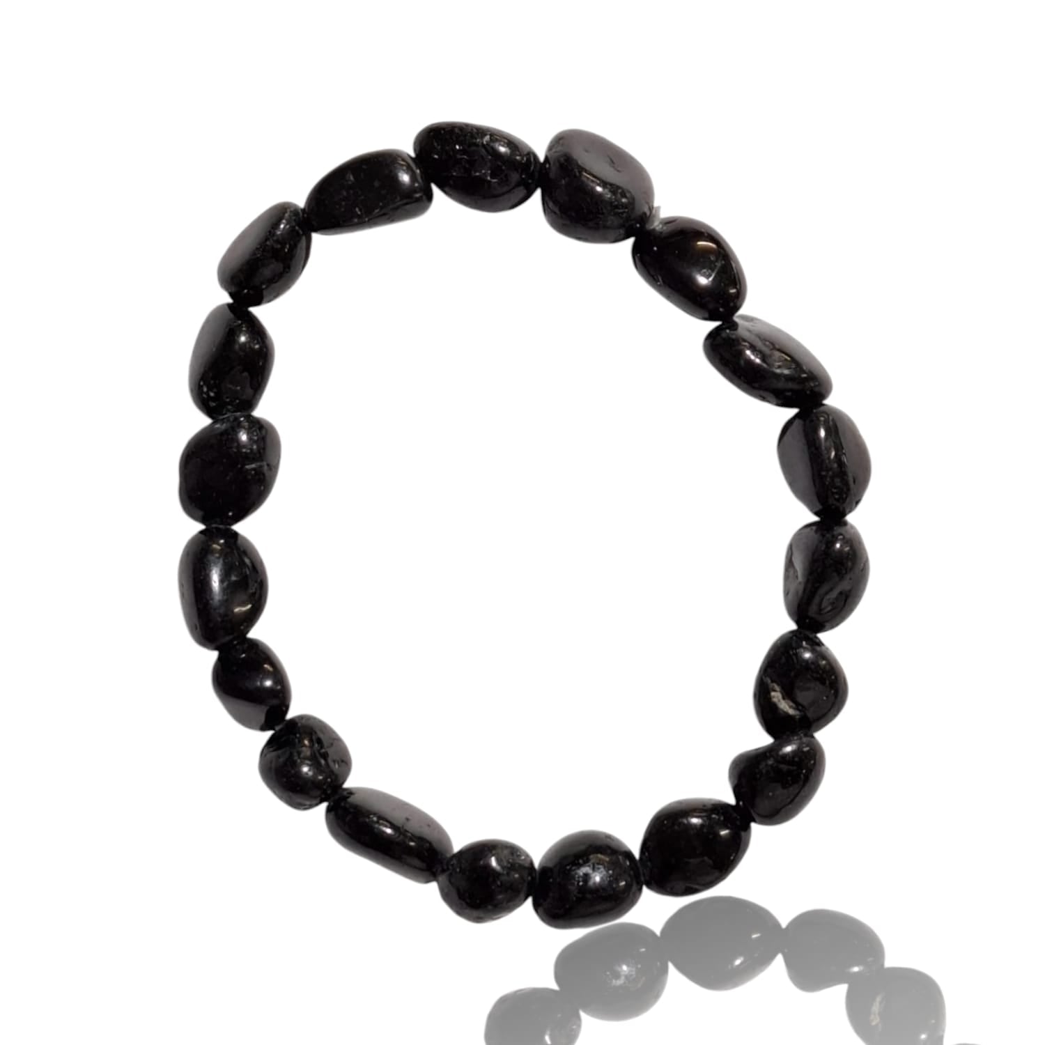 GeoFossils stretch nugget bracelet made from black tourmaline stones, featuring deep, opaque black hues with a subtle natural sheen. The stones are irregularly shaped and polished, retaining a raw, earthy texture. The elastic band provides a flexible fit, and the bold, protective energy of the black tourmaline creates a grounding, minimalist aesthetic.