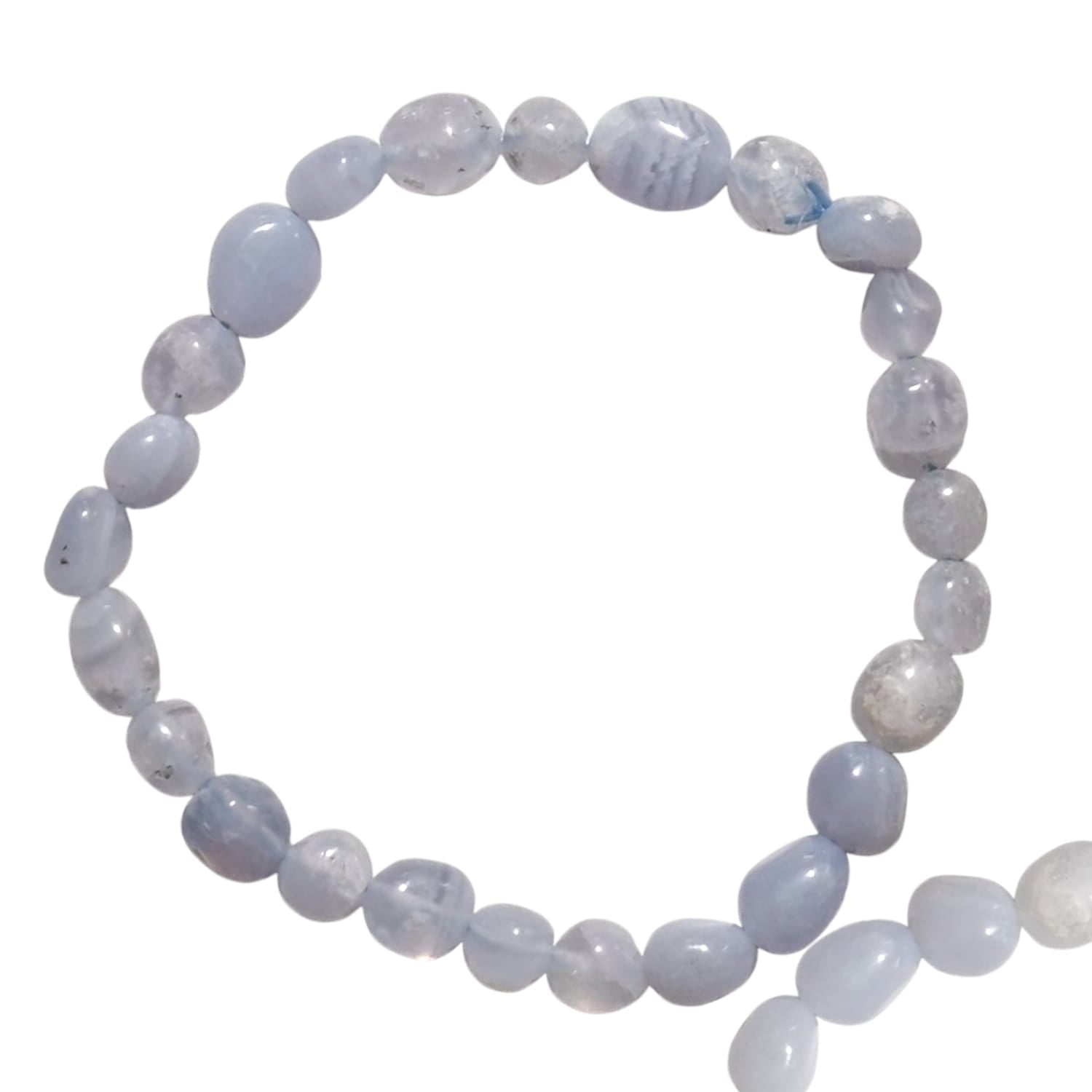 GeoFossils stretch nugget bracelet crafted from blue lace agate stones in soft pastel shades of pale blue with delicate white banding. The stones are irregularly shaped and polished, showcasing their natural patterns and calming appearance. The elastic band allows for a comfortable, adjustable fit, while the soothing, airy tones of blue lace agate evoke a sense of tranquility and serenity.