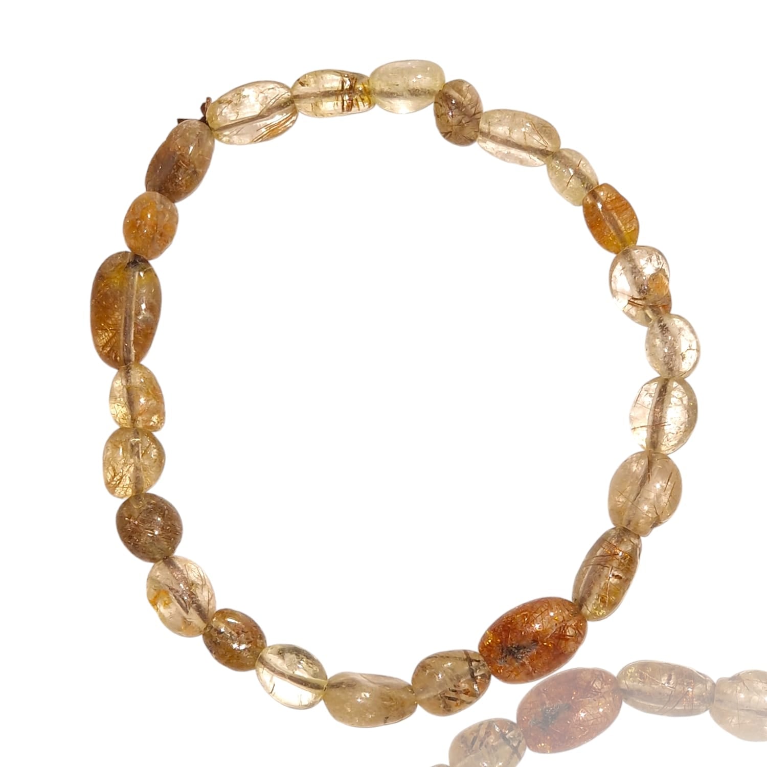 GeoFossils stretch nugget bracelet made from golden rutile stones, showcasing translucent quartz with fine, needle-like inclusions of golden yellow rutile. The stones are irregularly shaped and polished, allowing the radiant, hair-like rutile strands to catch the light and create a striking visual effect. The elastic band provides a comfortable, adjustable fit, and the vibrant golden hues of the rutile inclusions add a touch of elegance and energy.