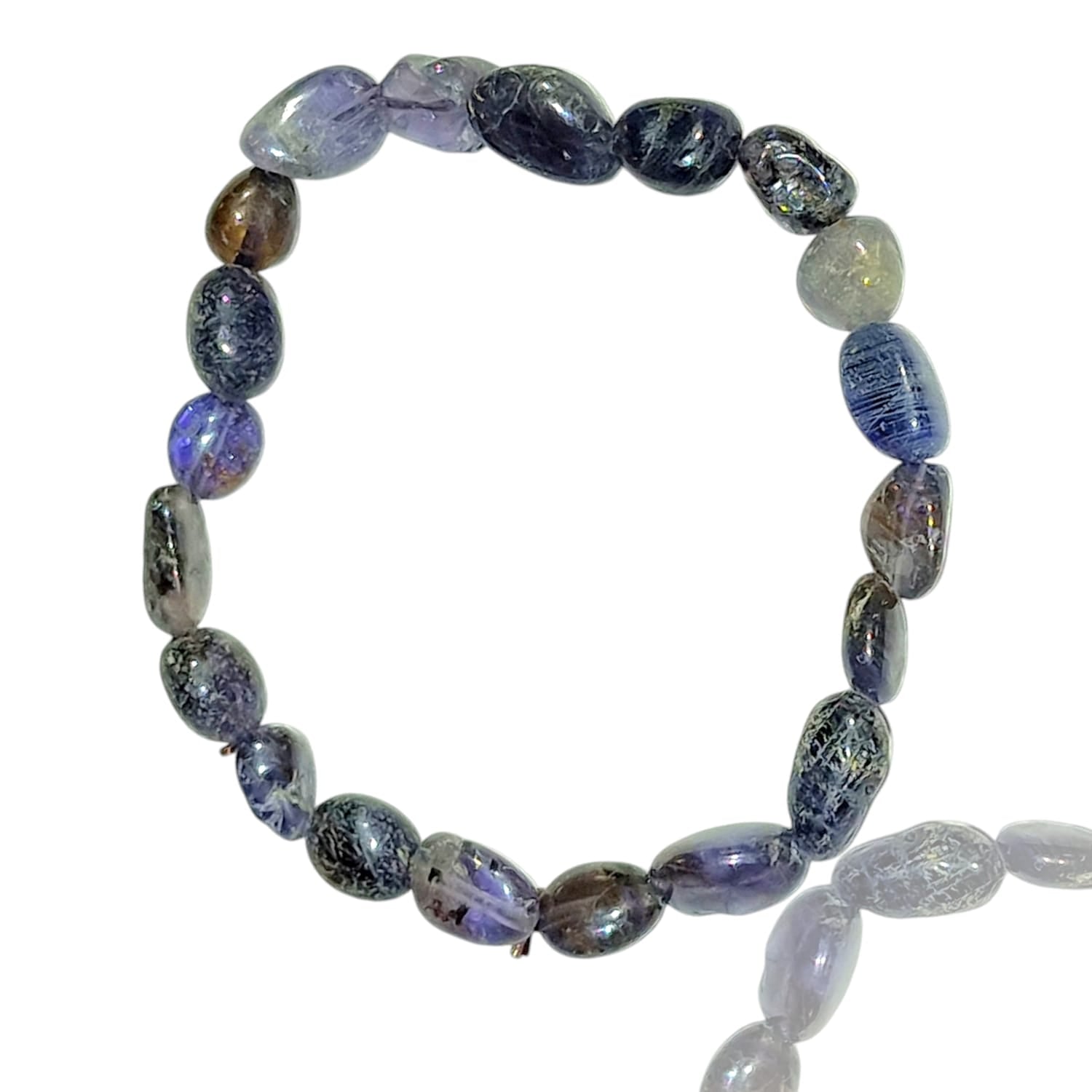 GeoFossils stretch nugget bracelet made from iolite stones, showcasing deep blue, indigo, and violet hues with a subtle, translucent quality. The stones are irregularly shaped and polished, highlighting their natural depth and light-reflective properties. The elastic band provides a comfortable, adjustable fit, and the rich, cool tones of iolite evoke a sense of calm, intuition, and mystical energy.