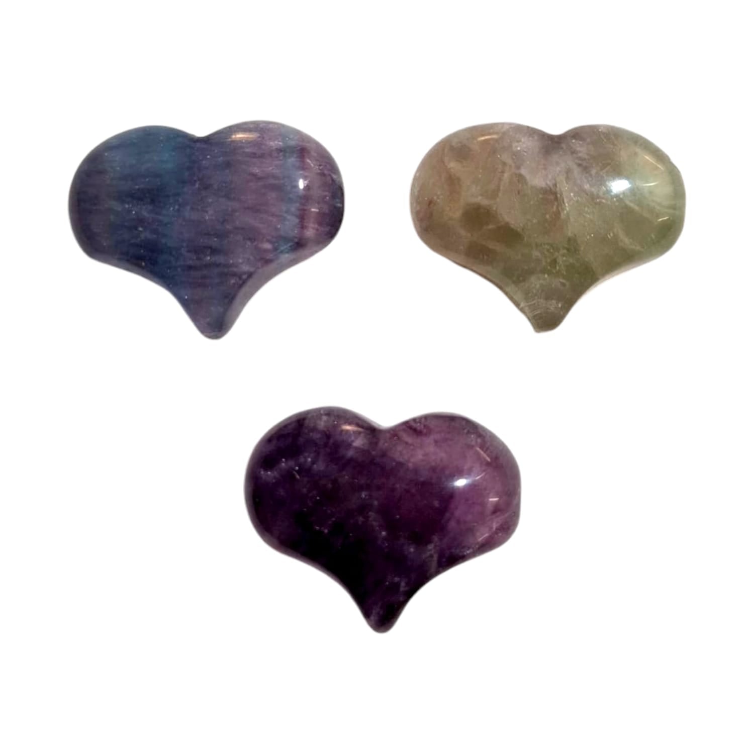 A small, polished puff heart crafted by GeoFossils from fluorite, displaying a blend of translucent colours, including shades of green, purple, and clear bands. The heart has a smooth, rounded shape, highlighting the stone’s natural striations and soft, layered appearance. The calming, multi-coloured look of the fluorite heart evokes a sense of clarity, focus, and harmony.