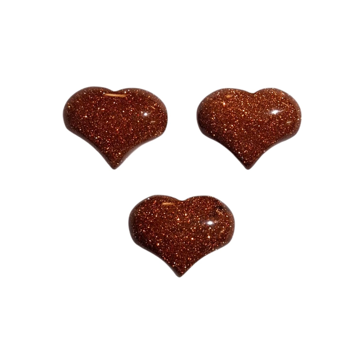 A small, polished puff heart crafted by GeoFossils from red goldstone, featuring a rich reddish-brown colour with a dazzling, glittery finish due to tiny, sparkling copper flecks. The heart has a smooth, rounded shape that enhances its shimmering appearance. The vibrant, sparkling look of the red goldstone heart evokes a sense of warmth, positivity, and uplifting energy.